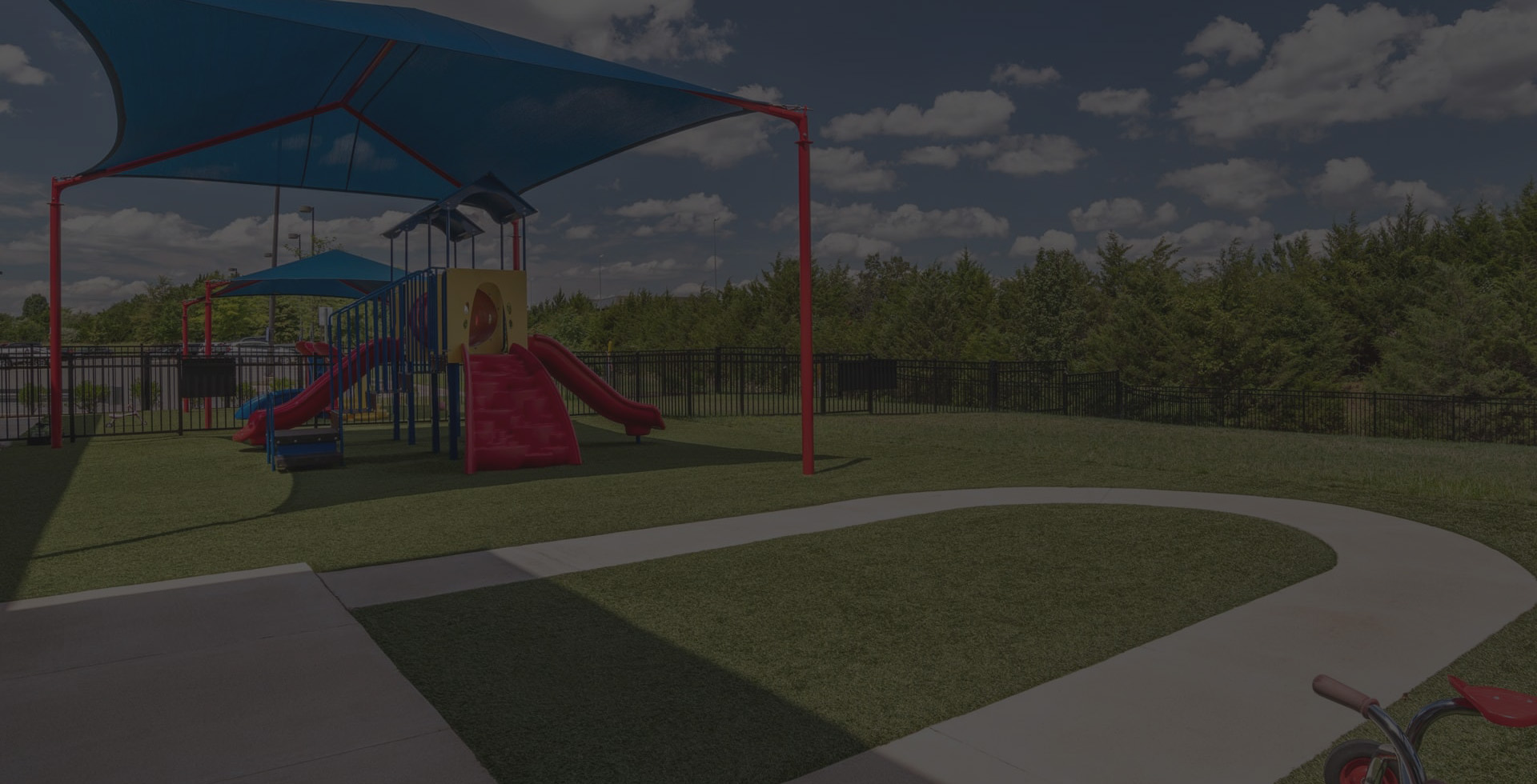 A background image of a playground at Kiddie Academy